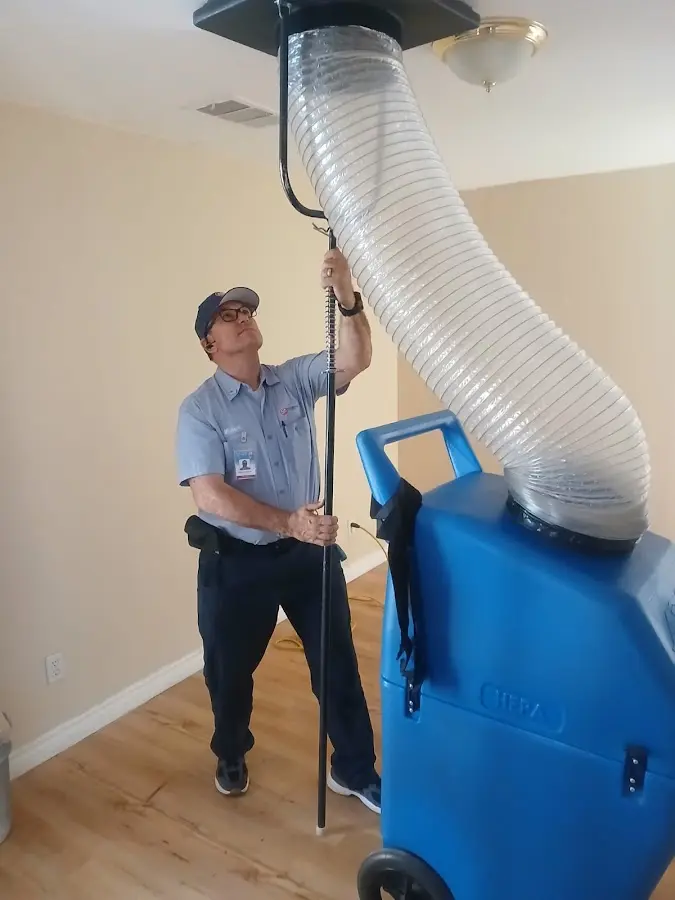 Furnace Tune-Up technician using HEPA equipment in Harrison